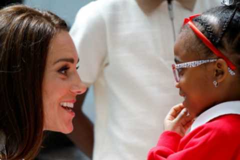 Touching moment Kate Middleton crouches down to shake hands with kids at Windrush Monument unveiling