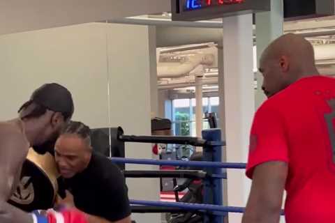 Watch Deontay Wilder’s coach take punch flush on chin from fearsome boxer but stay on his feet in..