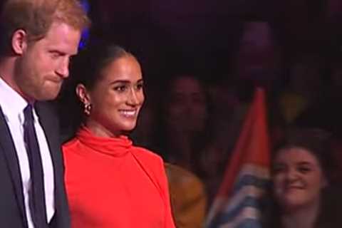 Meghan Markle beams as she takes to stage with Prince Harry and joins Bob Geldof ahead of speech