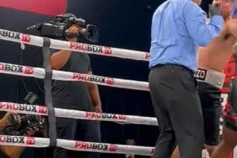 Watch boxer punch referee flush in the face but official takes it like a champ and gets on with job