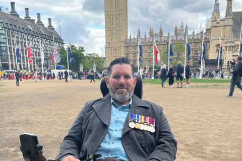 Incredible moment wheelchair-user Army hero struggles to his feet to salute the Queen one last time