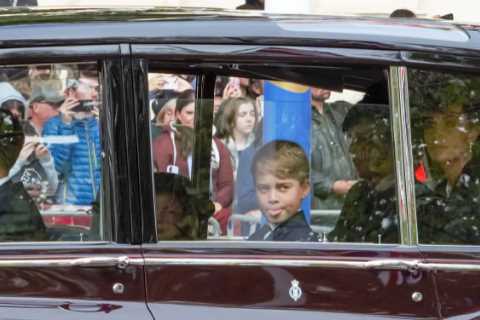 Cheeky Prince George spotted poking out his tongue as he sits next to Charlotte after Queen’s..