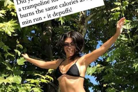 Kourtney Kardashian shows off her curves in a very tiny black bikini as she jumps up and down amid..