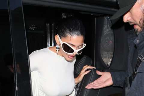 Kylie Jenner shows off her post-baby curves in skintight white dress as she arrives to Paris..
