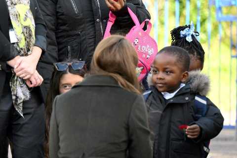 Princess of Wales hands her poppy to a 3-year-old boy on visit to children’s centre in London