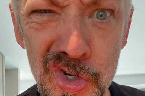 Boy George greeted by his classic hit Karma Chameleon stepping into five-star hotel after leaving..