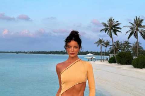 Maura Higgins shows off her washboard abs as she poses on Maldives beach in cut out dress
