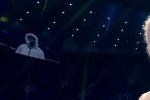 Itauma wraps up in hooded jacket during ring walk on Tyson Fury vs Derek Chisora undercard to..