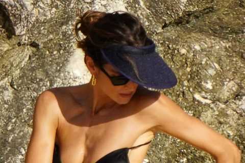Izabel Goulart looks stunning in tiny bikini on beach as she helps partner Kevin Trapp get over..