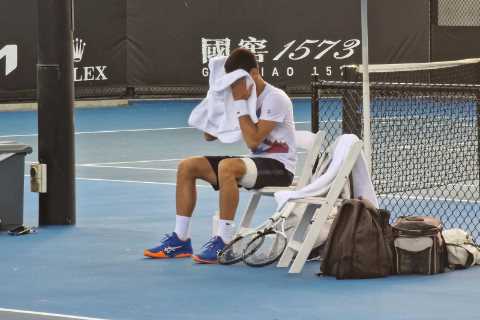 Fears Djokovic could pull out of Australian Open as he practises with heavily-strapped leg after..