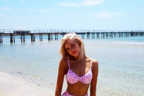 Morgan Riddle stuns in pink bra and trousers on the beach before Taylor Fritz’s Australian Open..