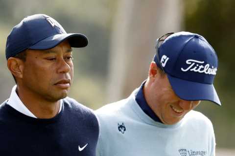 Paige Spiranac reacts after Tiger Woods hands Justin Thomas a TAMPON after being outdriven at..