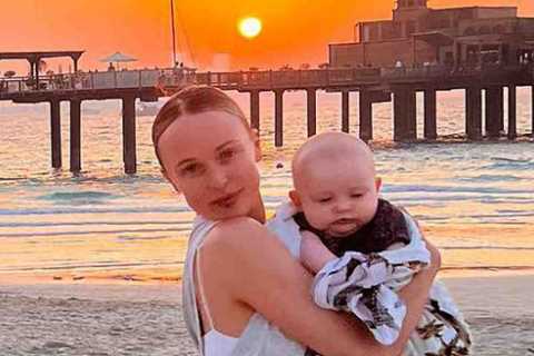 Jorgie Porter shows off natural beauty as she cuddles baby son on the beach on holiday