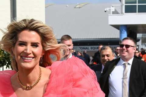 Sarah Jayne Dunn stuns as she goes braless in bright pink dress for day at the races