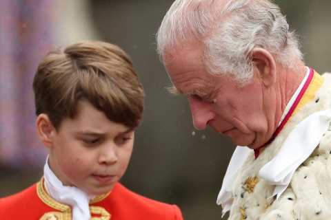 Prince George, 9, looks solemn as he holds his grandfather King Charles’ robe in special role at..