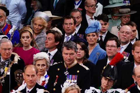 Prince Harry smiles despite sitting in third row after arriving separately from brother William at..