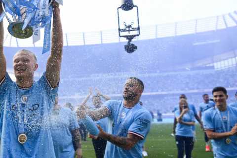 Erling Haaland drenched in champagne by Man City team-mates as record goal-scorer hoists Premier..