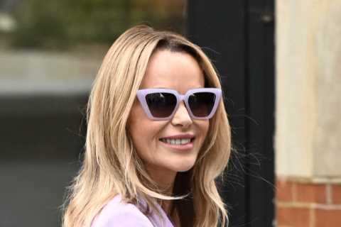 Amanda Holden goes braless and shows off her tanned legs in lilac mini-suit