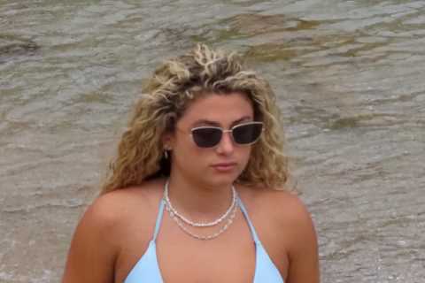 Love Island’s Antigoni flashes her bum in blue thong bikini as she soaks up the sun on holiday