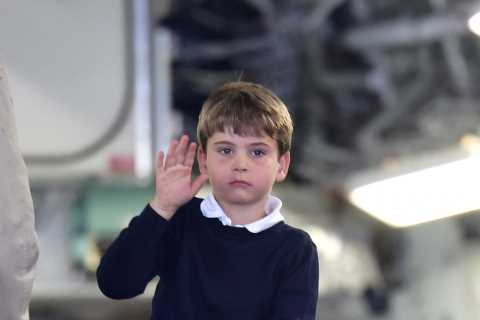 Prince Louis gives a shy wave as Kate helps him climb onto a quad bike during family day out with..