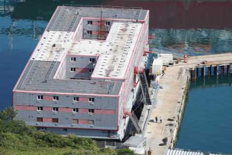Plans to house 500 migrants on huge three-storey barge delayed AGAIN over fears they will burn it..
