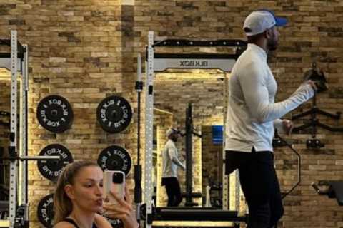 Strictly’s Zara McDermott shows off her toned bum in very tight gym gear as she stretches during..