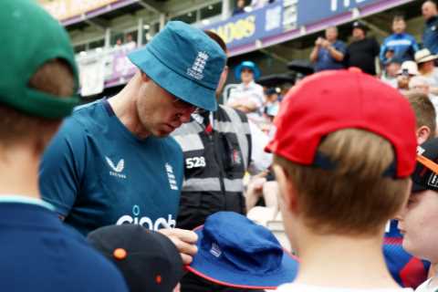 Andrew Flintoff smiles and signs autographs for fans as he coaches England cricket team after..