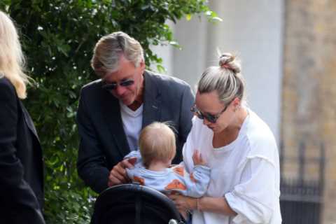 Richard Madeley showcases his doting grandfather side as he cuddles baby Bodhi on a family outing