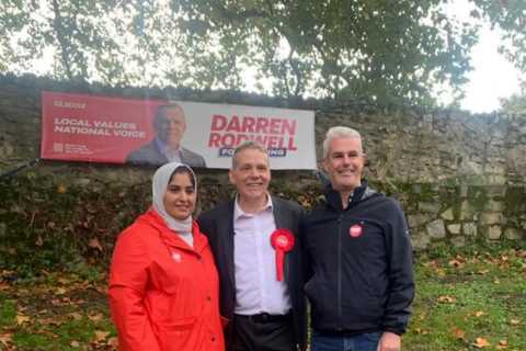 Fury as Labour candidate criticized for using gravestones to hang election campaign banner