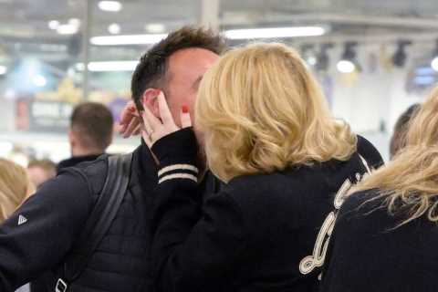 Ant McPartlin shares a passionate kiss with wife Anne-Marie as they reunite at Heathrow Airport