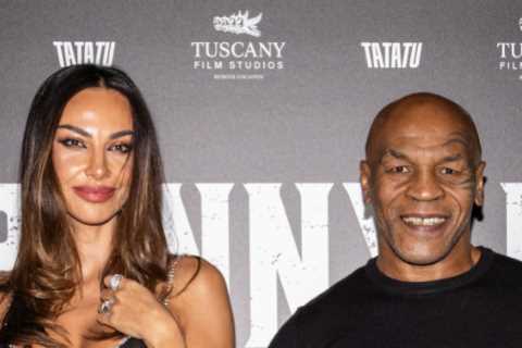 Mike Tyson poses with stunning tennis Wag Madalina Ghenea on the red carpet at event for boxing..