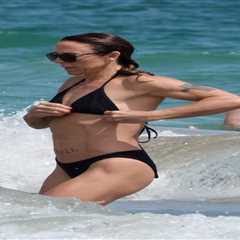 Mel C flaunts washboard abs in black bikini as she hits the beach in Ibiza